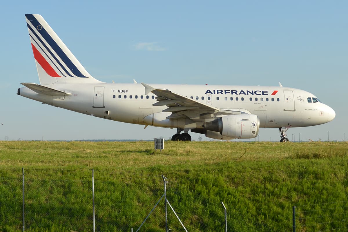 An Air France Airbus A318-111, registration F-GUGF, in the carrier's white fuselage with blue titles and striped tail, seen at Paris-Charles de Gaulle Airport.