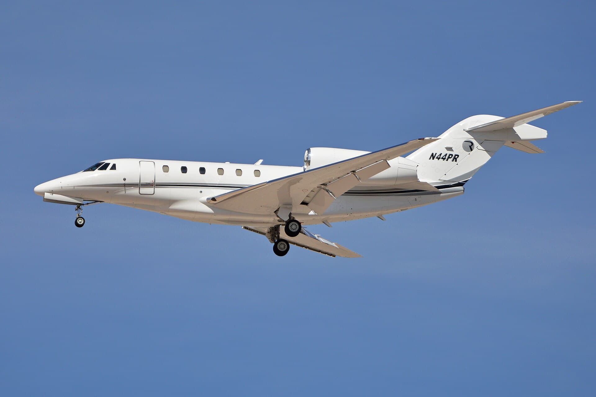 A white Cessna 750 Citation X registered N44PR, with swept wings and rear-mounted engines, photographed on the ground at Harry Reid International Airport in Las Vegas under bright daylight.