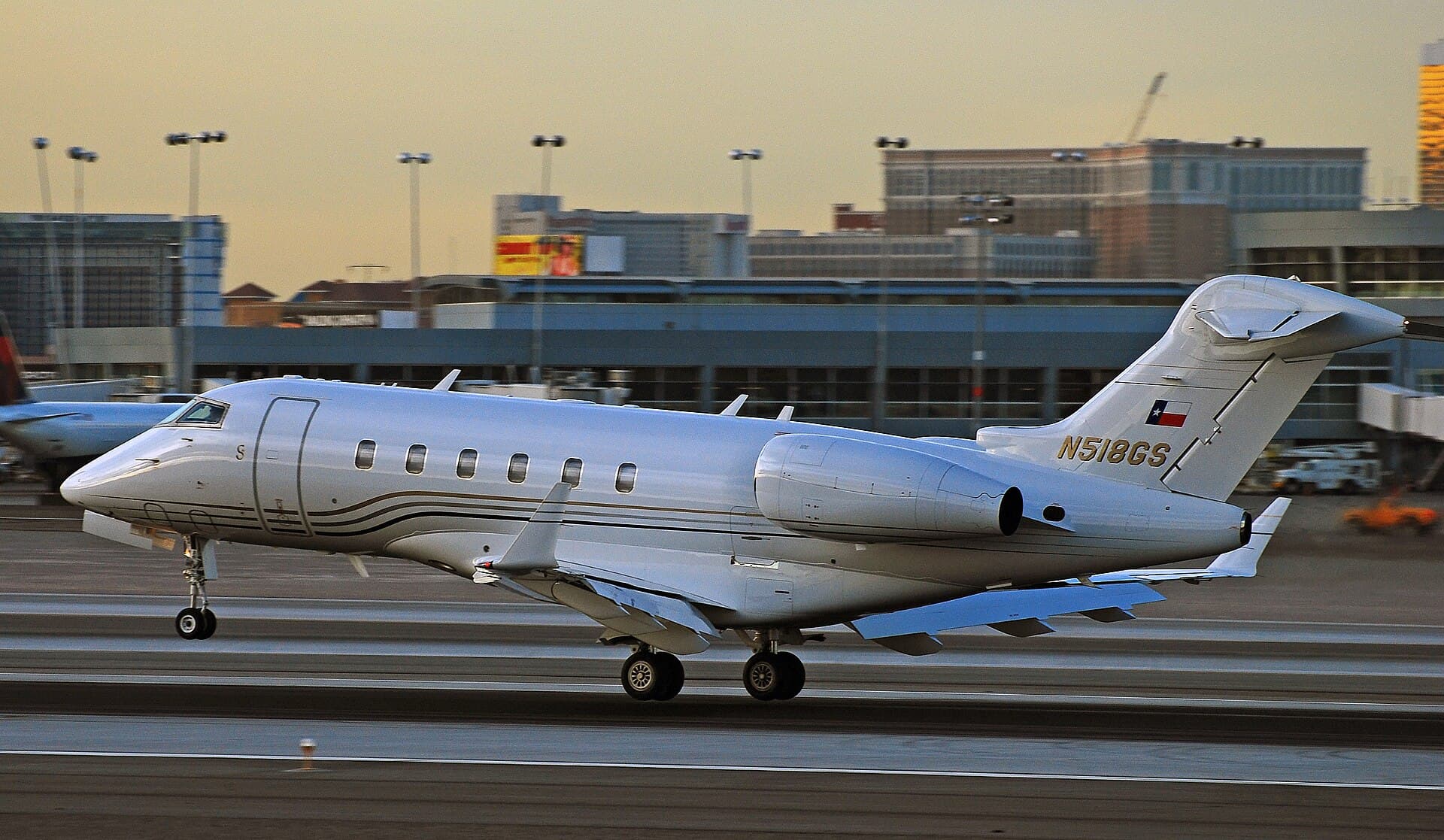 A white Bombardier BD-100-1A10 Challenger 300 business jet registered N518GS, photographed in daylight at Las Vegas McCarran International Airport in February 2011.