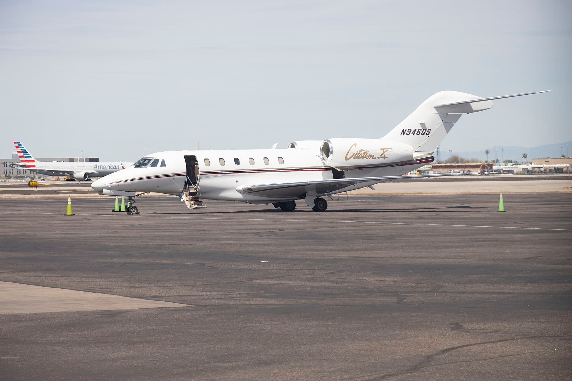 A Cessna Citation X in NetJets livery, registration N946QS, photographed at Phoenix Sky Harbor International Airport on a clear spring day.