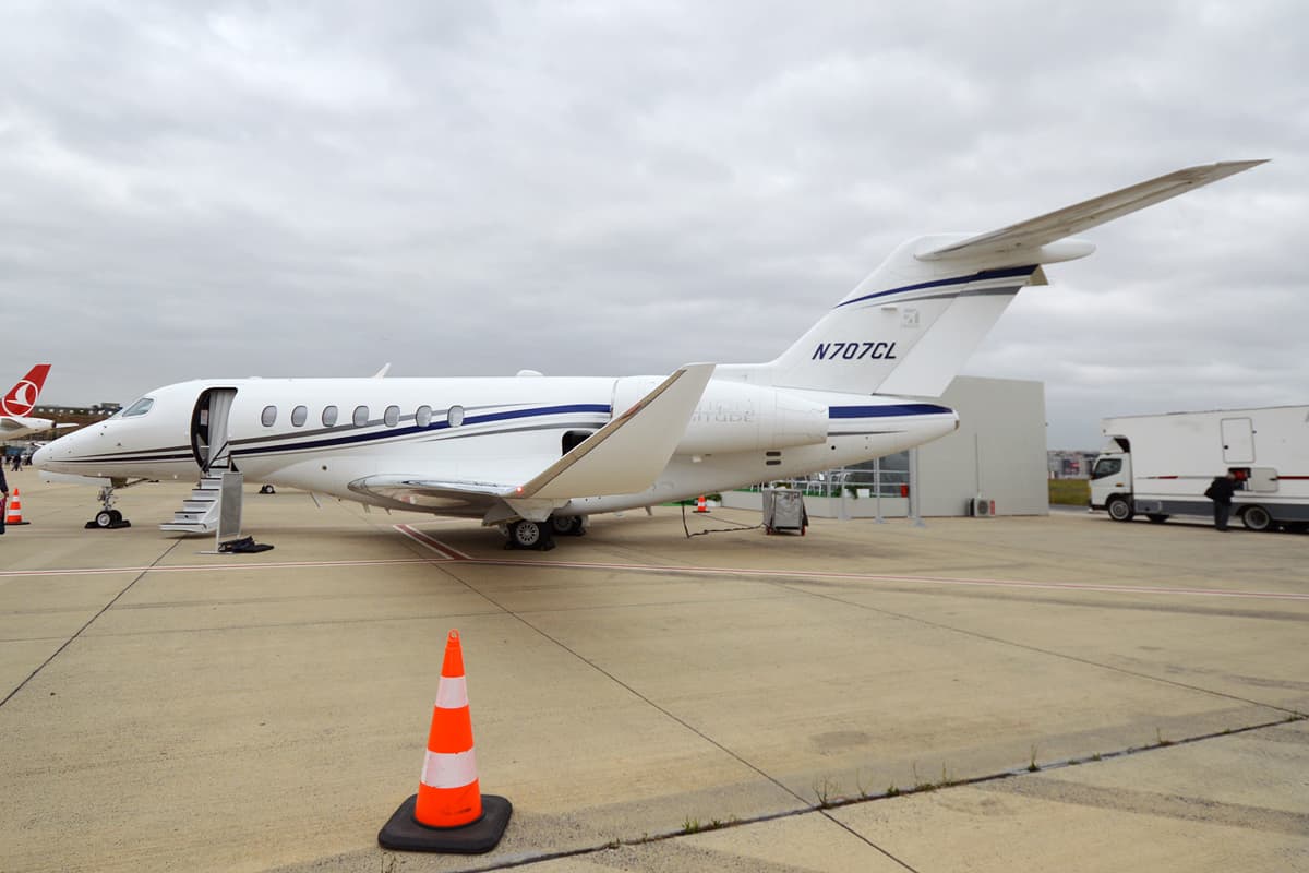 A white Cessna Citation 700 Longitude in Textron Aviation house colours, registration N707CL, shown in side view with its swept wing and T-tail.