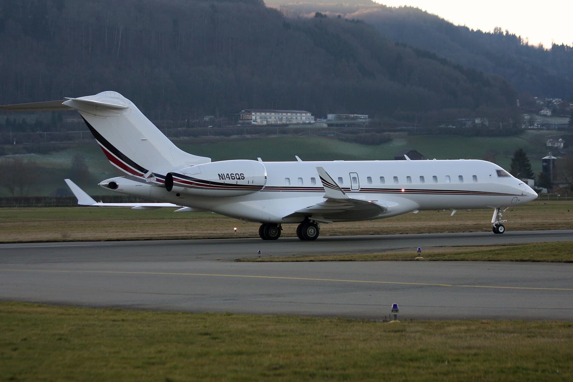 A Bombardier Global 6000 business jet registered N146QS, in NetJets livery, photographed at Bern-Belp Airport in Switzerland in December 2015.